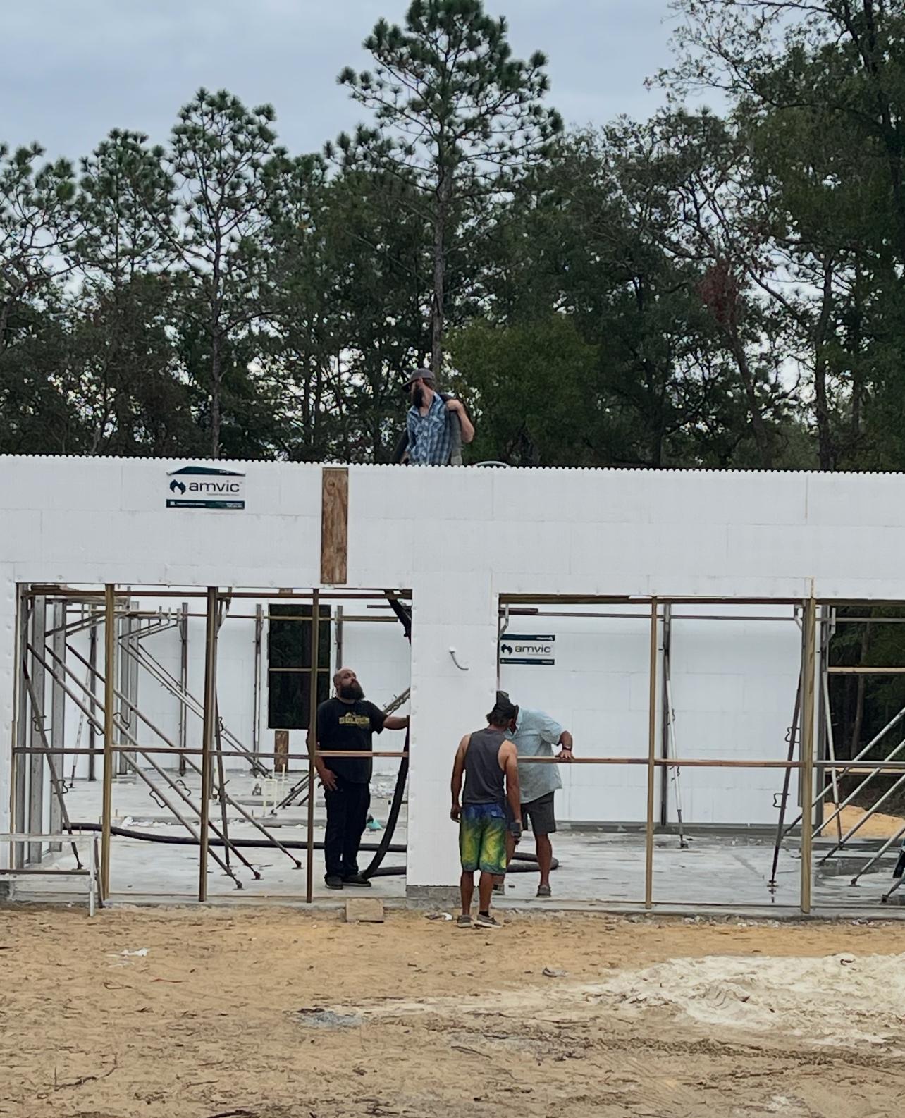 Construction crew positioning ICF wall braces